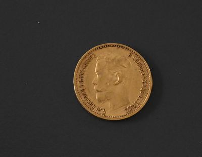 a close up of a gold coin on a black surface