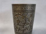 an image of a metal cup with a pattern on it