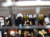 many bottles of wine sitting in a metal basket