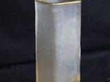 a glass vase that is sitting on a black surface