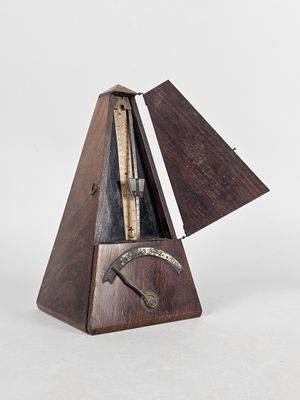 an image of a musical instrument with a wooden body and a metal handle