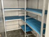 a blue shelf in the corner of a room