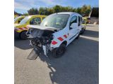 the front of a white van that has been damaged and is sitting in a parking lot