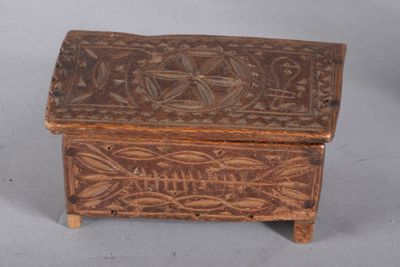 a small wooden box with a design on it