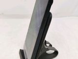 a cell phone that is on a stand on the table