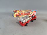 a small toy fire truck with a box on the table