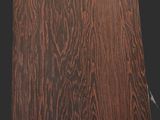 a close up of a wooden panel with a black background