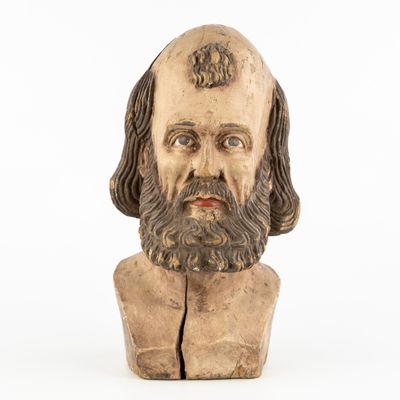 an old wooden bust of a man with a beard and long hair