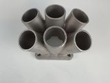 a close up of a metal pipe holder on a white surface