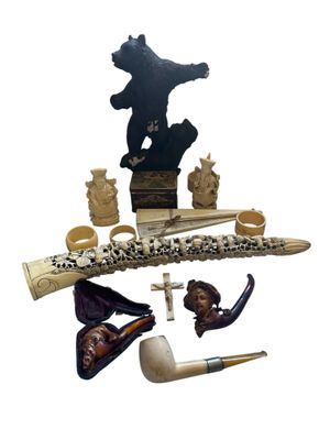 a picture of a collection of items that include a bear, a pipe, a hat, and other items