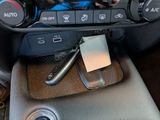 a picture of a car dashboard with a phone in it