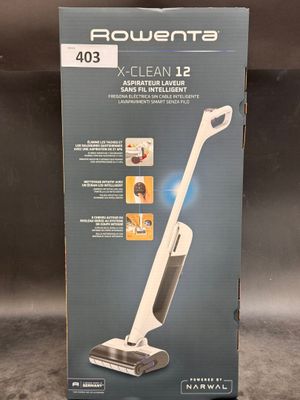the box of a vacuum cleaner is open on the floor