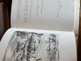 a book open on a table with a drawing on it