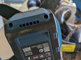 a blue and black electric tool sitting on a table
