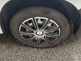 a white car with a black rim parked in a parking lot