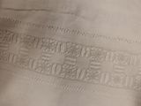 the back of a white jacket with a black and white picture on it