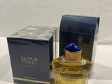 a close up of a bottle of perfume next to a box
