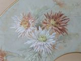 a fan with flowers painted on it in a room