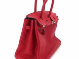 a red handbag on a white background
