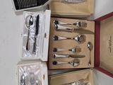 a lot of silverware in a box on the table