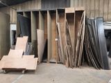 many pieces of wood stacked up in a warehouse