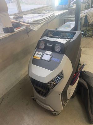 a machine that is sitting on the ground in the garage