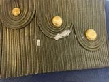 a close up of a purse with gold buttons on it