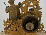a statue of a man riding on a horse with a bell