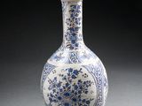 a blue and white vase sitting on a table