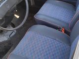 a picture of the interior of a car with blue and red seats