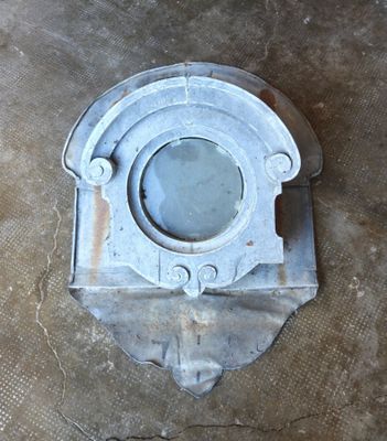 a metal object on the floor with a hole in it