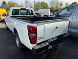 a white pick up truck parked in a parking lot