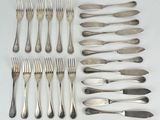 many forks and spoons laid out on the table