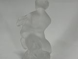 clear glass figurine of a man with a hat on his head