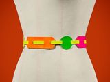 an image of a woman wearing a colorful belt with a green circle on it