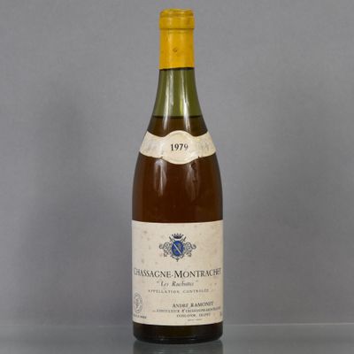 an old bottle of wine sitting on top of a glass table