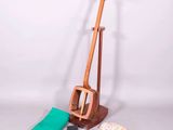 an image of a wooden instrument with a green cloth and other items