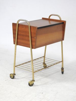 une petite table en bois avec un piètement métallique et des roulettes