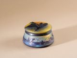 a small blue and yellow object on a white surface