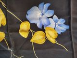 a painting of blue and yellow flowers on a black background