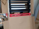 a pile of boxes and a chair in a room