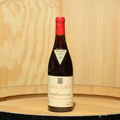 une bouteille de vin posée sur un tonneau en bois