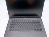 an open laptop computer sitting on top of a white table