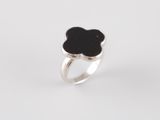 a silver ring with a black flower on top of it
