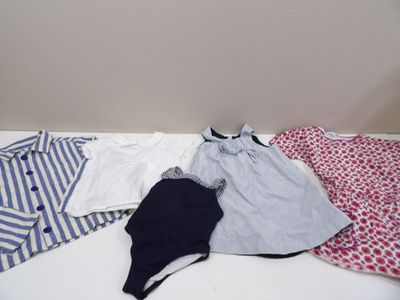 a bed with clothes on top of it in a room