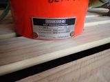 a red bucket sitting on top of a wooden table