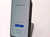 the back of a phone with a blue button on the display