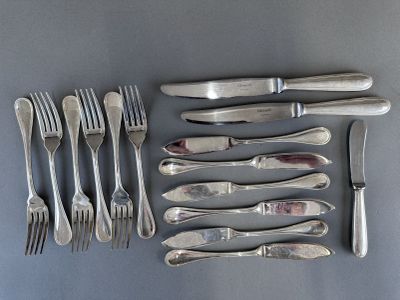 a lot of silverware on a table with a knife and fork