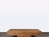 une photo d'une table basse en bois posée sur un sol en béton