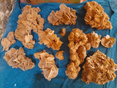 many pieces of paper that are on a blue cloth
